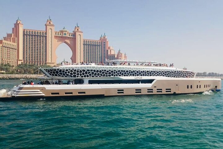 Experience luxury on the Lotus Mega Yacht gliding past iconic Dubai landmarks while enjoying live music delicious meals and refreshing drinks—an unforgettable way to sail the stunning coastline.